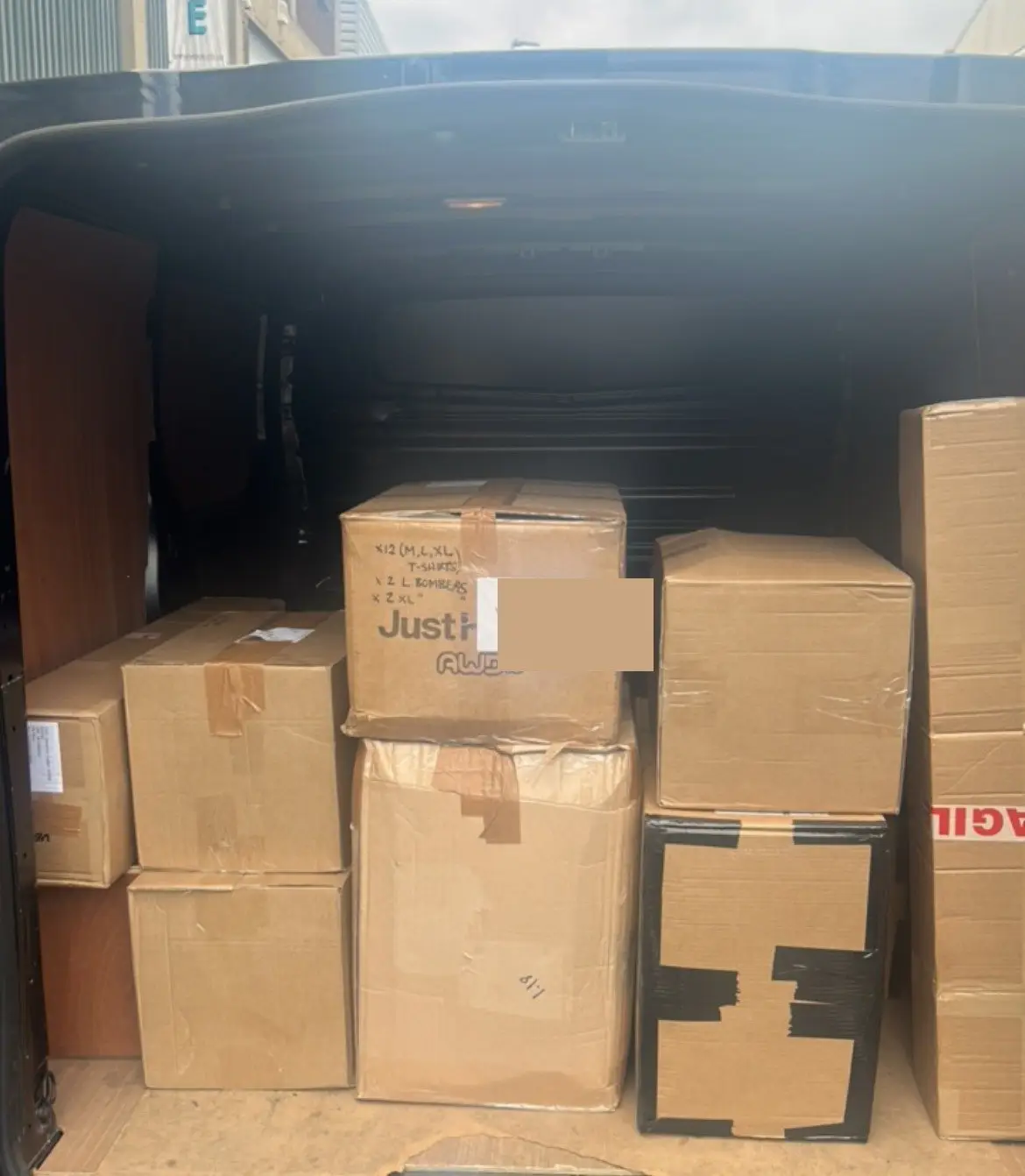 A van loaded and ready to go, rear doors open